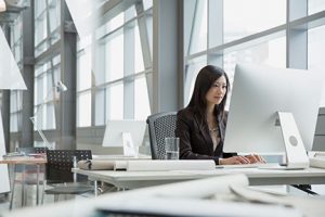 Asian woman using desktop computer