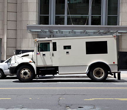 armored-car-sm Armored car parked in front of office