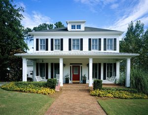 white colonial style home with front yard
