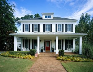 white colonial style home with front yard