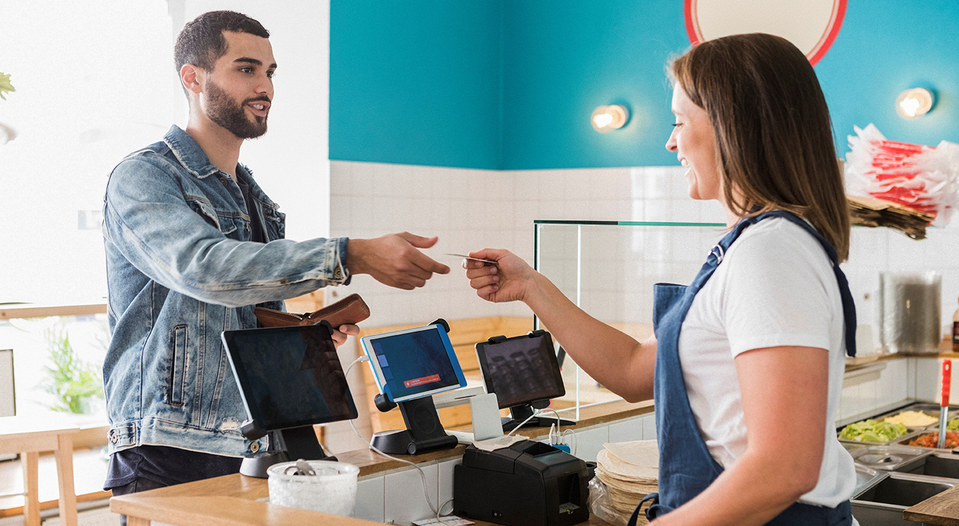 credit-card-restaurant2-med Man paying cashier in cafe