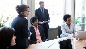 Diverse employees conducting meeting in conference room