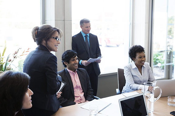 Diverse team in discussing government contract financing in conference room