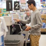 Man using debit card at self checkout