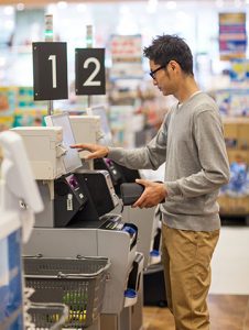 Man using debit card at self checkout