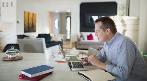 Man on laptop working from home