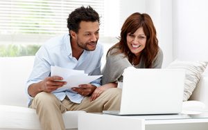 Couple reviewing finances on laptop