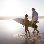 Retiree at beach with grandchild