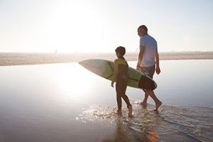 Retiree at beach with grandchild