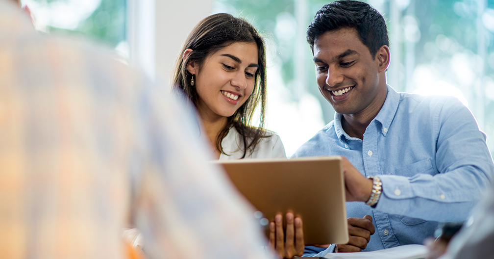 co-workers-reviewing-tablet-med co-workers reviewing tablet as they're starting a business