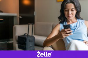 Hispanic woman using mobile device while traveling