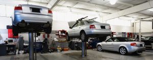 automotive repair shop with sedans on lifts