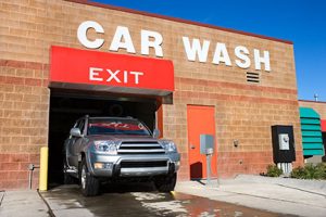 SUV exiting car wash establishment