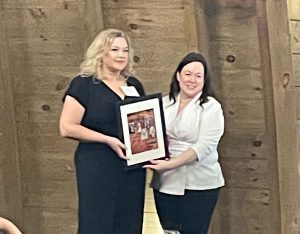 Kimberly Bradford receiving Influential Women Award from Prince William Living Magazine
