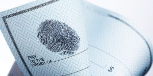 Paper check with thumbprint