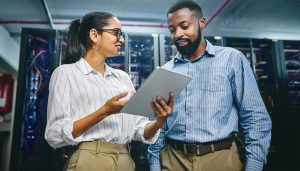 Diverse IT staff members with large servers in the background