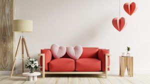 pink heart pillows on red sofa in living room