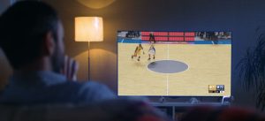 Home Pursuit man sitting on couch watching basketball game on tv