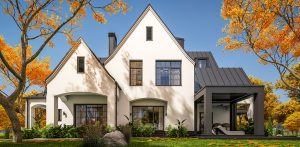 white tudor house with fall foliage